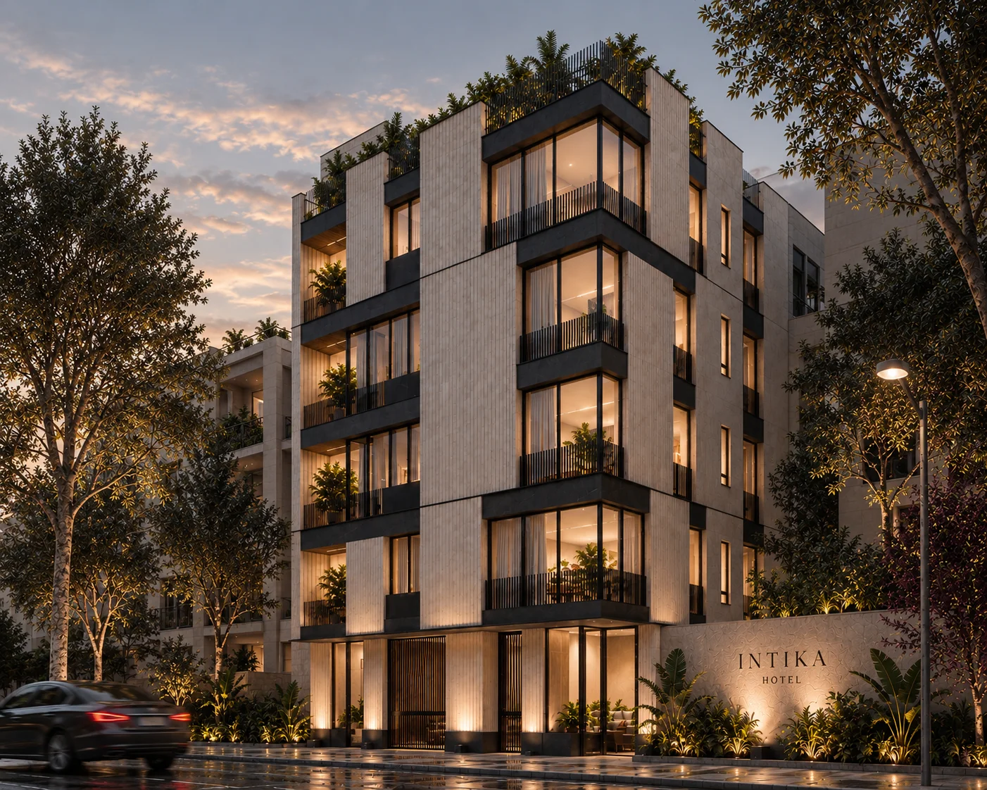 Boutique hotel façade in pale stone at dusk